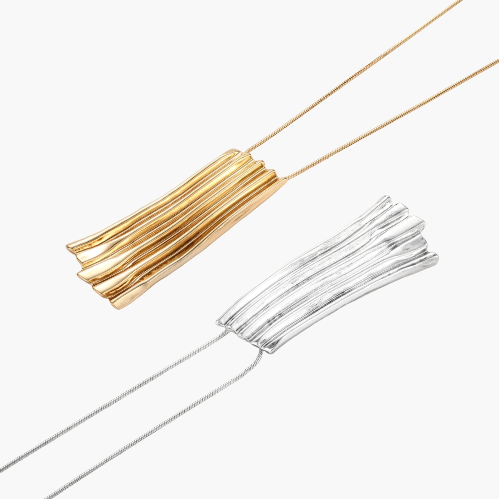 Modern adjustable necklace featuring geometric ribbed pendant with vertical lines in gold and silver finish options.