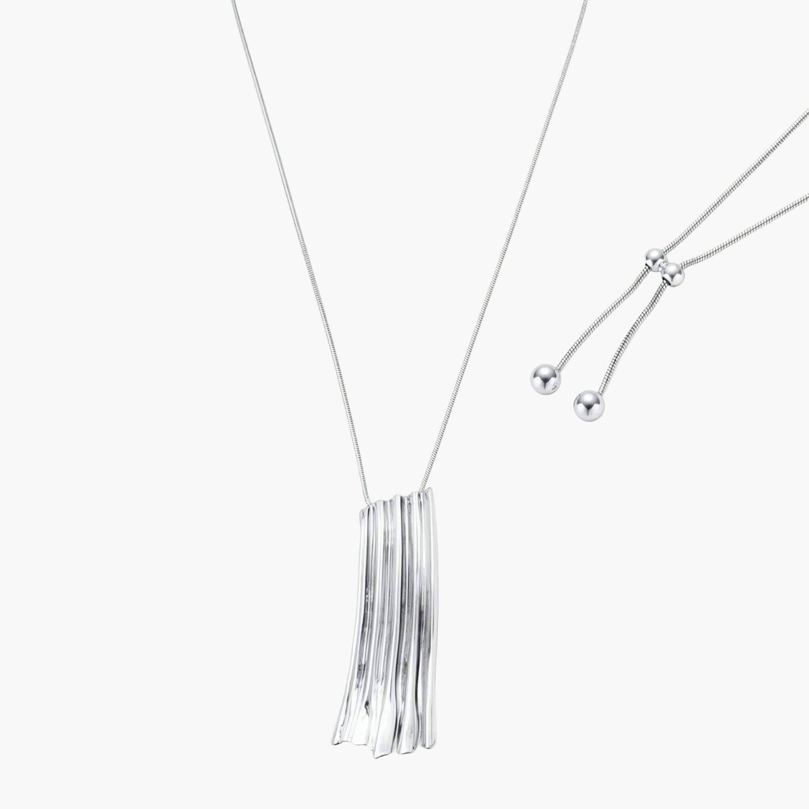 Modern adjustable necklace featuring geometric ribbed pendant with vertical lines in gold and silver finish options.