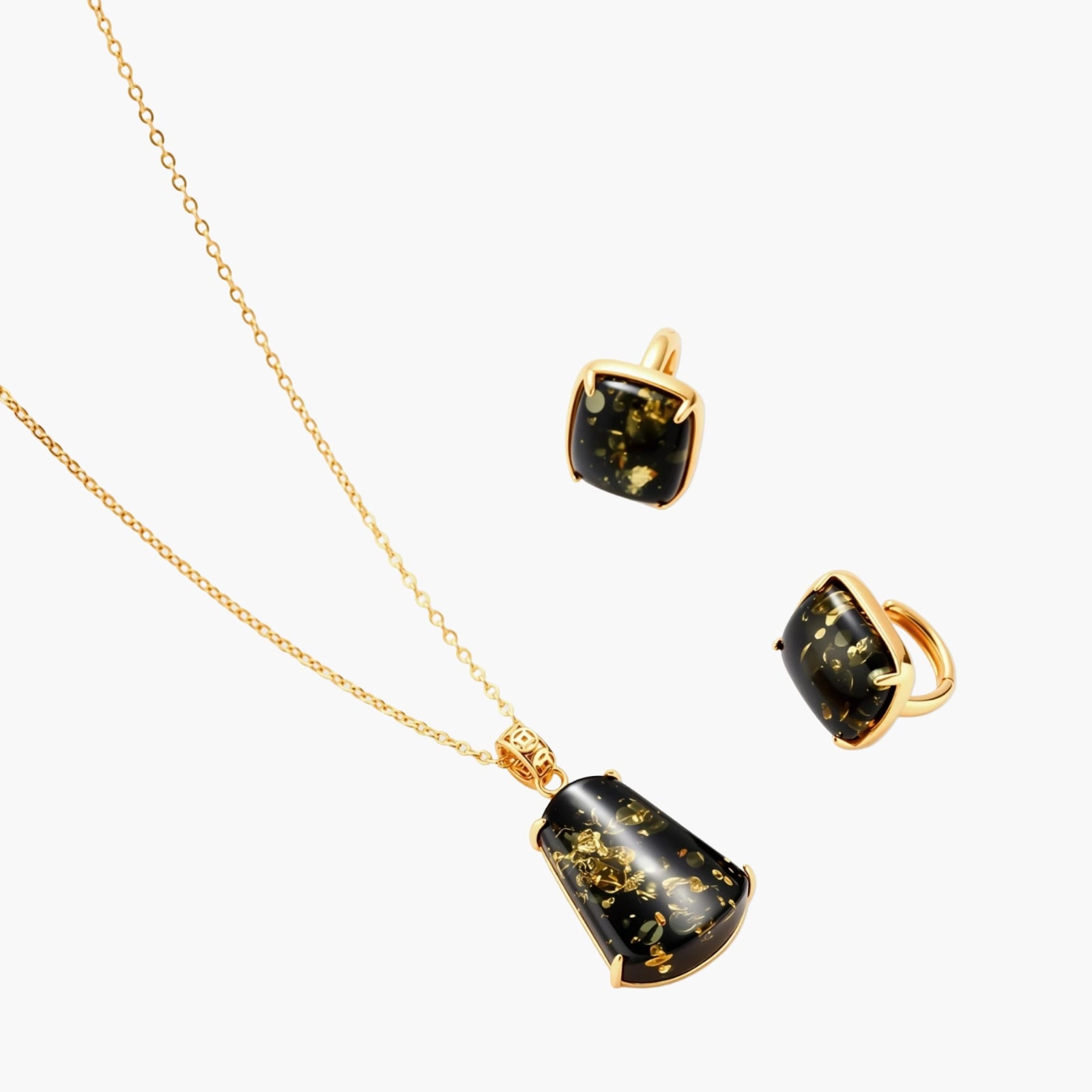 18k gold-plated necklace and earrings with green amber pendants featuring golden inclusions on cream background
