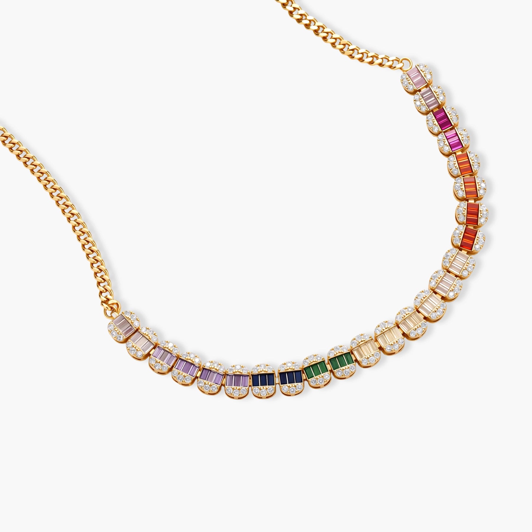 Gold-plated jewelry set featuring rainbow baguette-cut cubic zirconia stones in geometric design on cream background